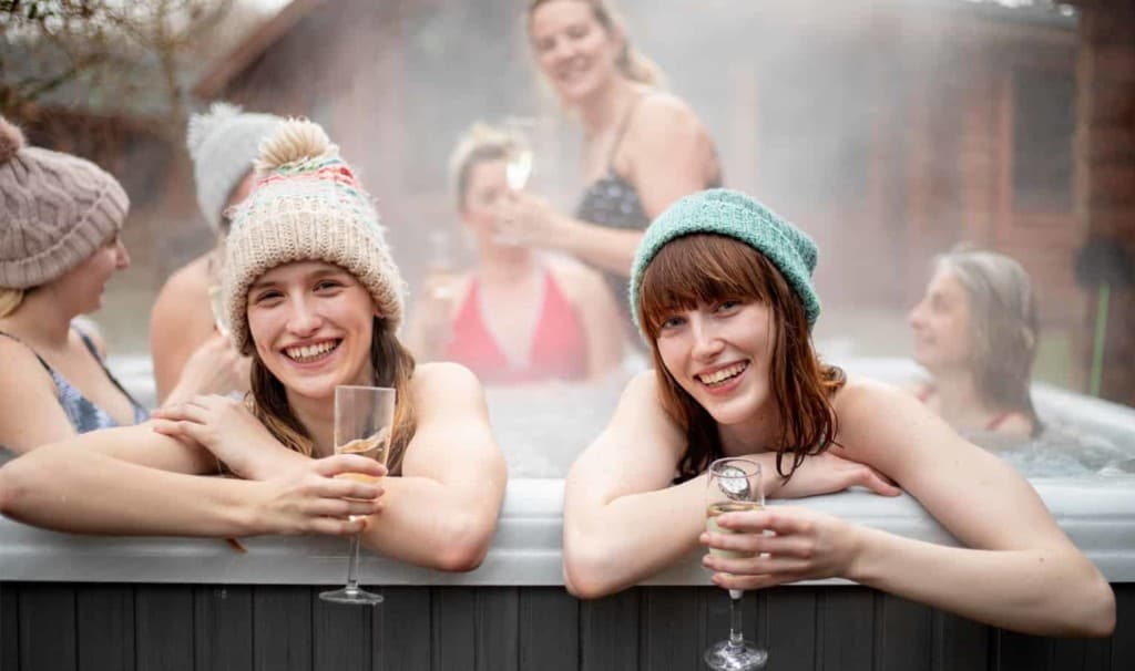 Friends celebrating in a hot tub