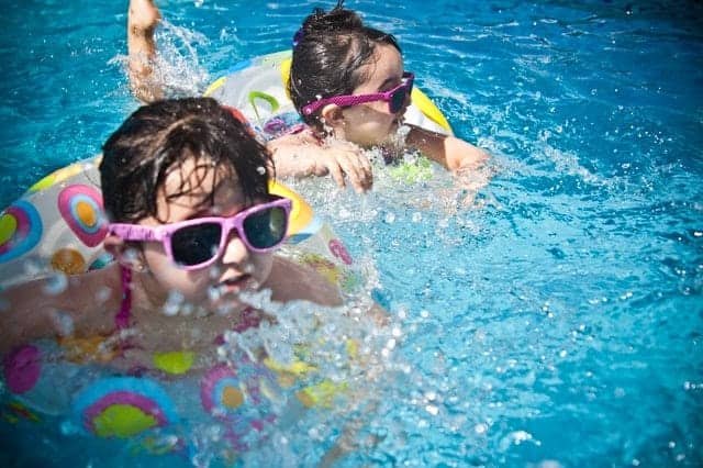 two kids swimming in fiberglass swimming pool in raleigh