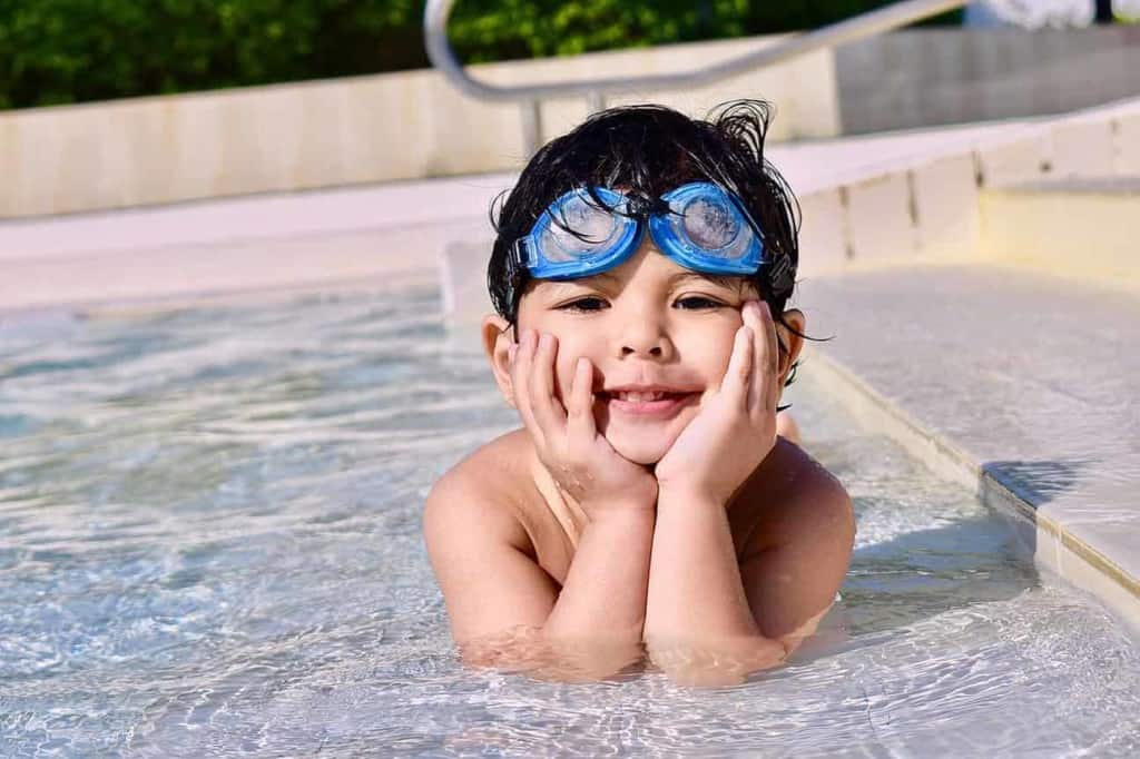 kid in fiberglass swimming pool