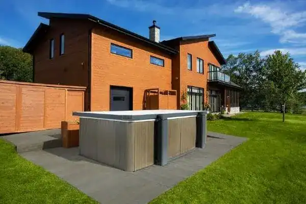 Backyard swim spa installation with an automated cover closed on a patio