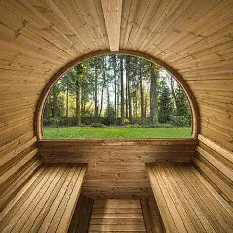 Interior of a cedar barrel sauna with facing bench seats
