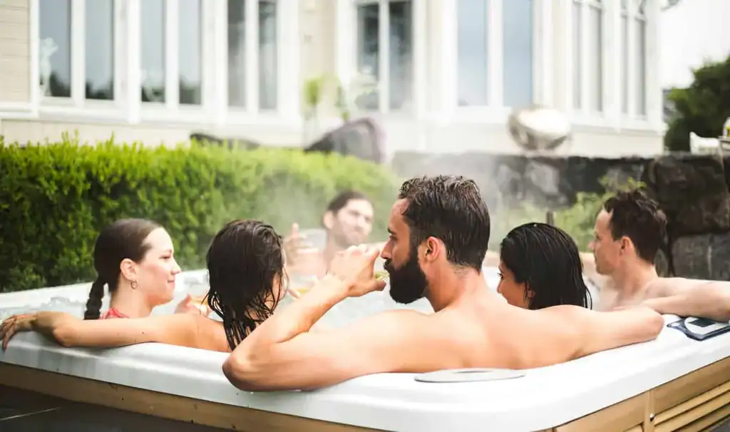 People relaxing and celebrating in a hot tub all year round