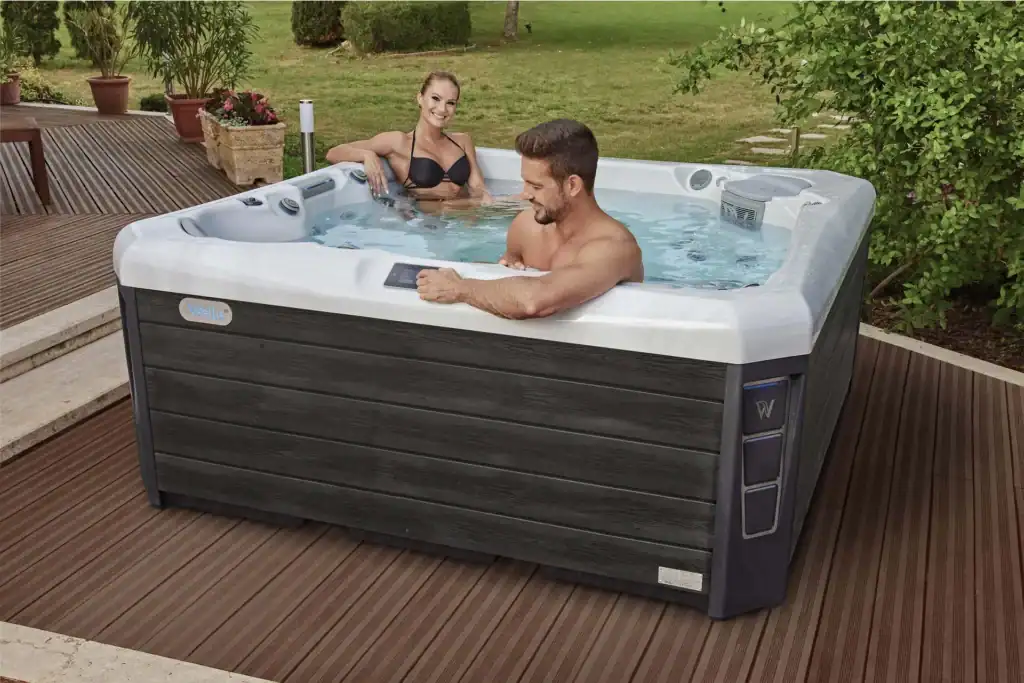 Energy efficient hot tub with insulated cover running outdoors