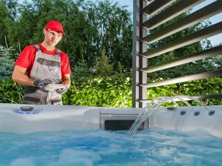 Hot tub technician performing regular maintenance to keep hot tub water from turning green