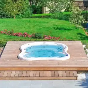 In ground hot tub placement flush with a wooden deck