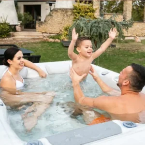 Parents supervising a young child playing in a hot tub