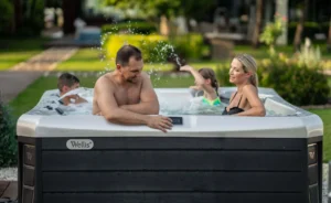 Family checking that the hot tub temperature is safe for kids