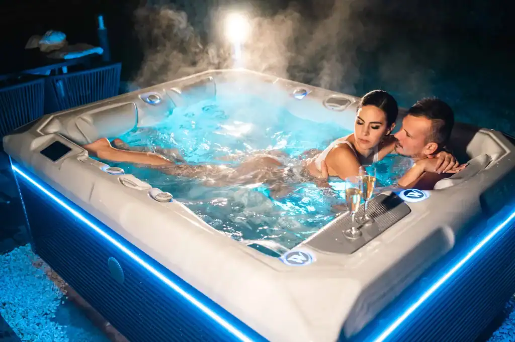 Small hot tub installed on an outdoor patio in a small backyard