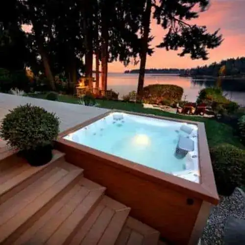 Split level hot tub installation on a terraced deck overlooking the water