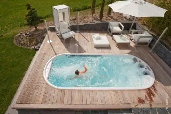 Swim spa built into a backyard wood deck